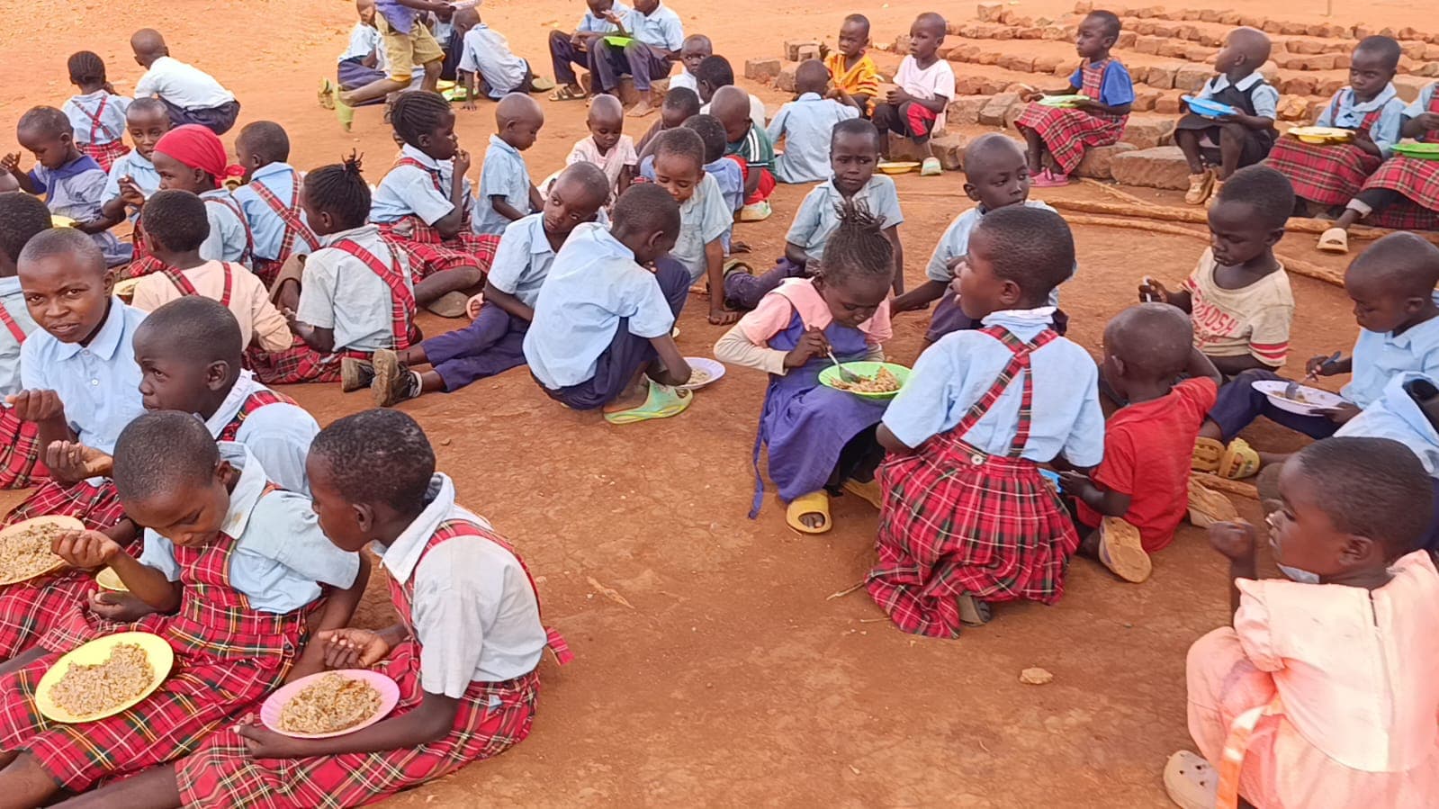 Children sharing a meal together, served through A Plate of Hope